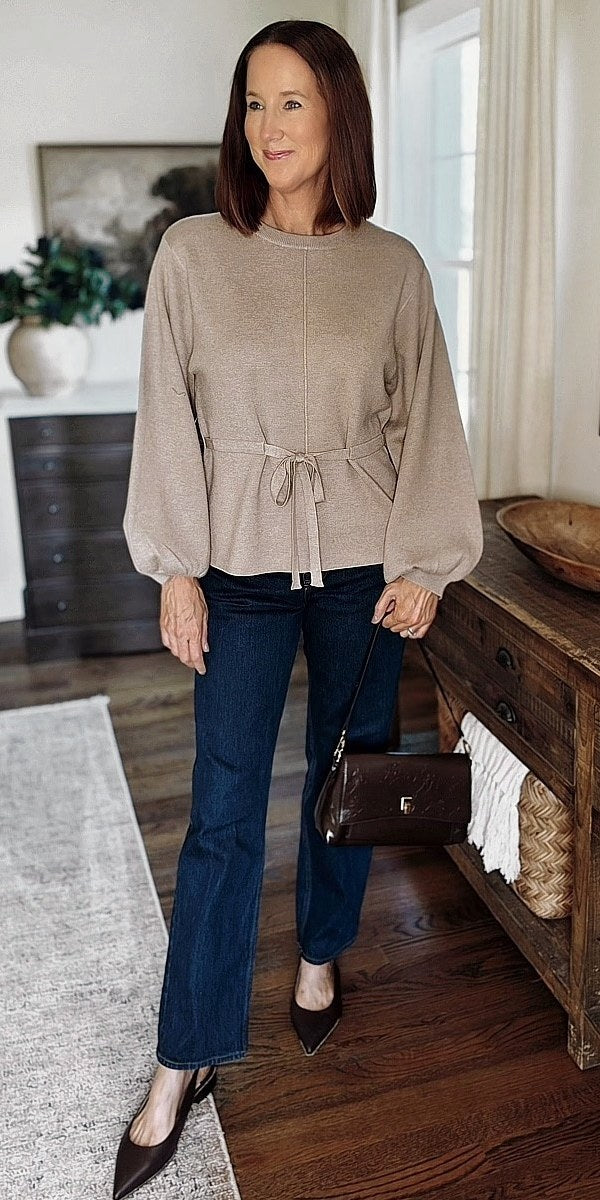 Taupe tie-waist sweater with dark straight-leg jeans